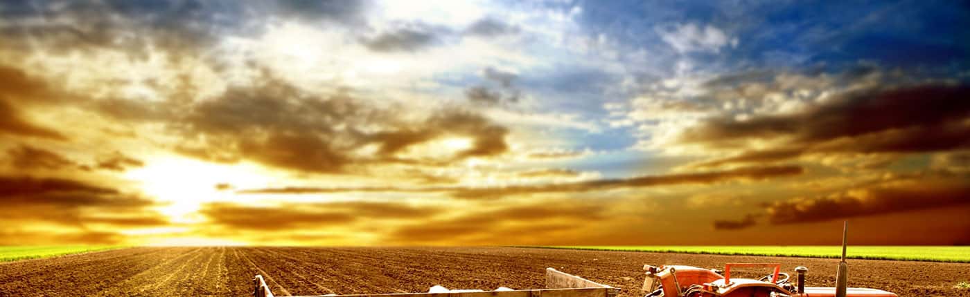 Image of a Freshly Ploughed field at Sunset with a tractor