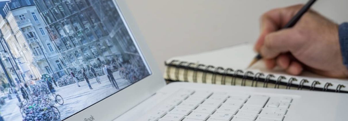 image of person writing on notepad about finance broker, commercial finance broker